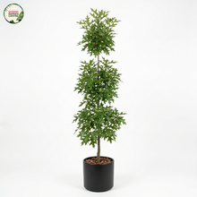 Load image into Gallery viewer, A tall, narrow artificial topiary-style tree with layered green leaves in a black cylindrical pot, photographed against a plain white studio background. A small 'Garden Center' logo appears in the upper left corner.
